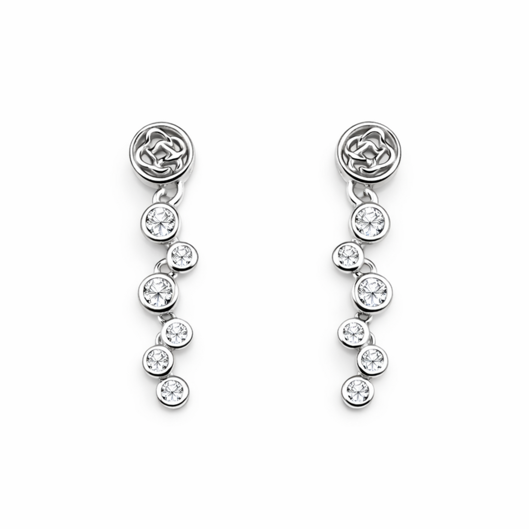 Pair of silver earrings with clear gemstones on a white background