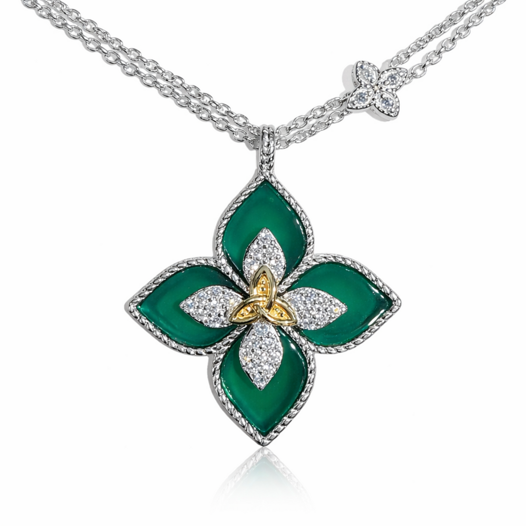 Green floral pendant with gold center on a silver chain against a white background