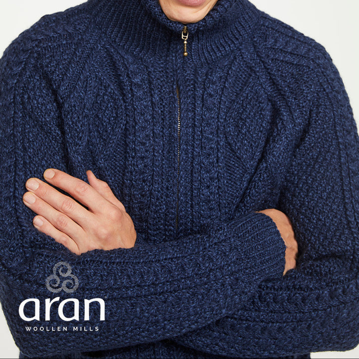 Man wearing a blue knitted sweater with Aran Woollen Mills logo.