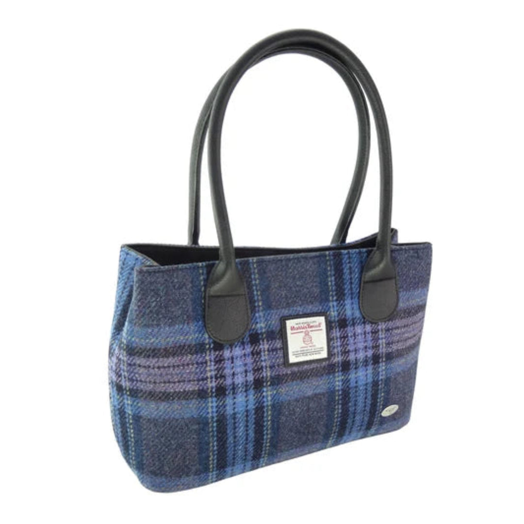 Blue plaid handbag with black handles on a white background