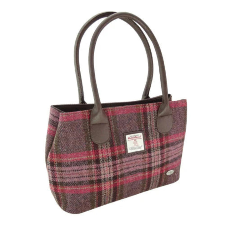 Plaid handbag with brown handles on a white background