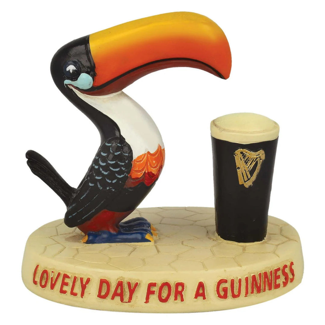 Toucan figurine with a Guinness cup on a white background