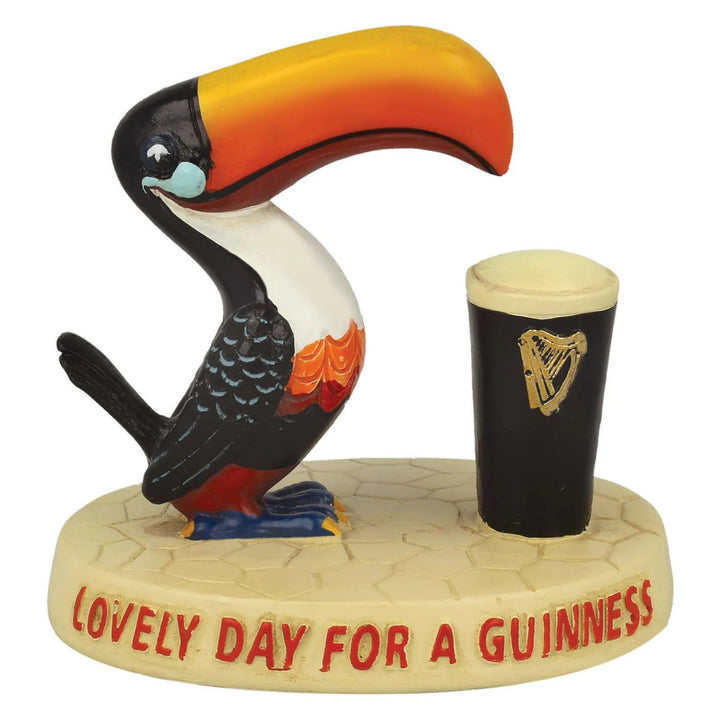 Toucan figurine with a Guinness cup on a white background