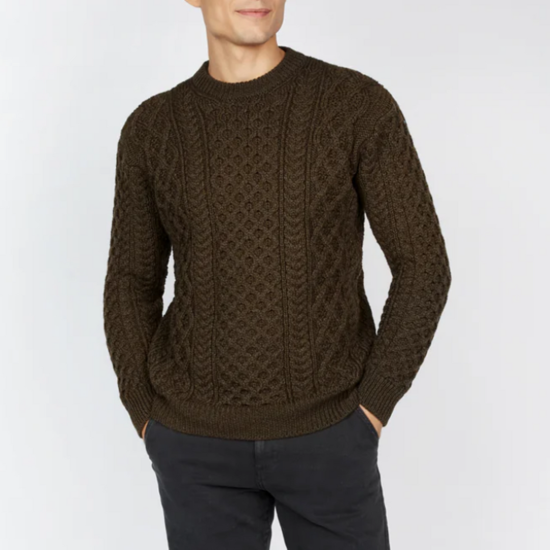 A man wearing a brown honeycomb pullover sweater.