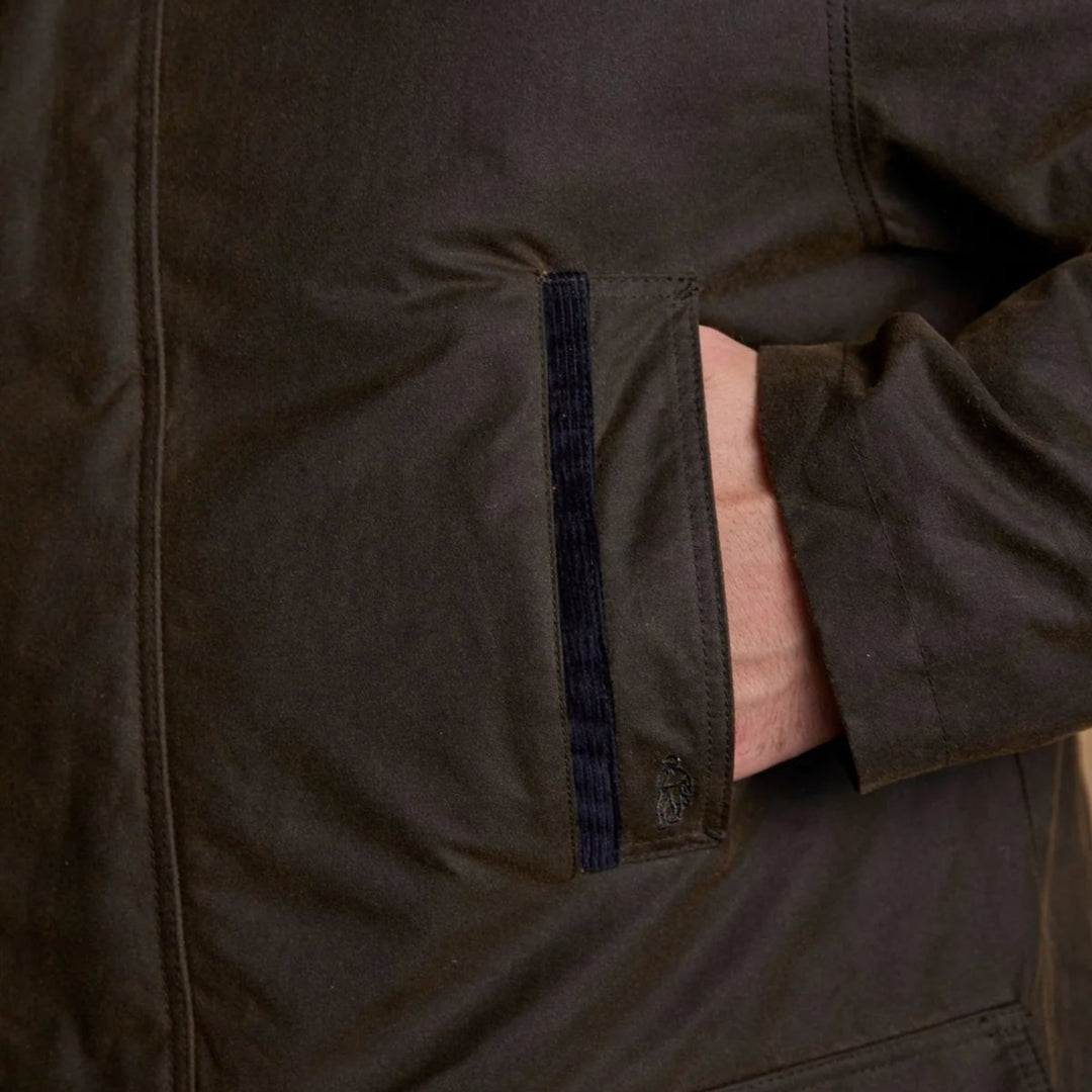Close-up of a brown jacket with a pocket and visible skin.