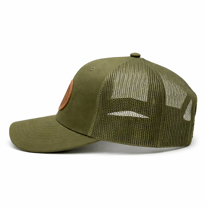 Green baseball cap from the side angle on a white background