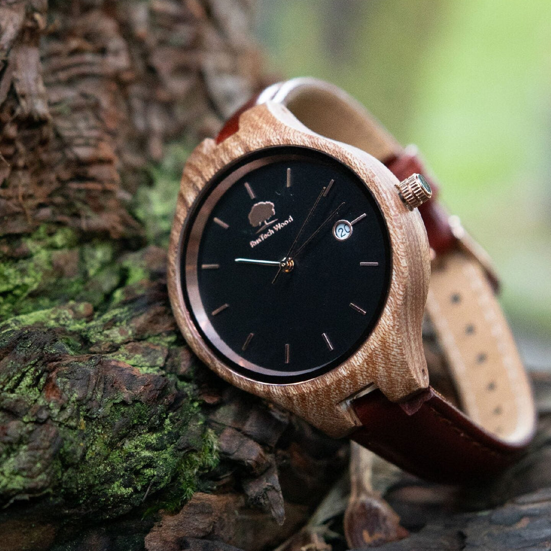 Wooden watch with brown strap on a tree branch