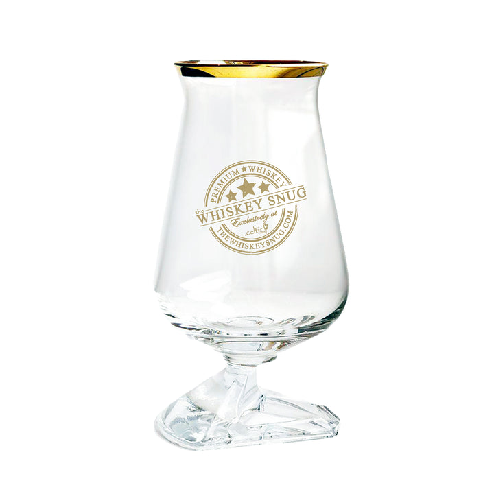 Clear whiskey glass with gold rim and 'Whiskey Snug' branding on a white background